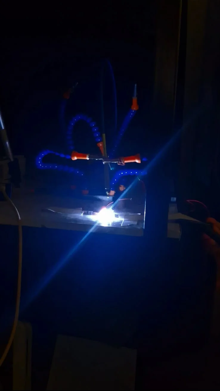 PenPlasma point discharge glowing on the bench in a darkened room
